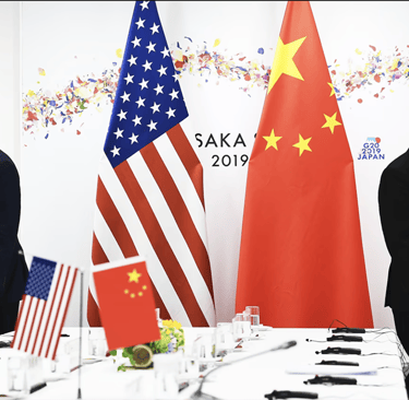 two men standing in front of a table with flags