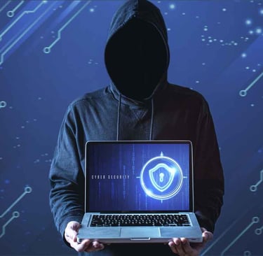 a person in a hoodie with a laptop computer