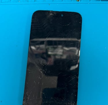 Cracked iPhone screen on repair workbench