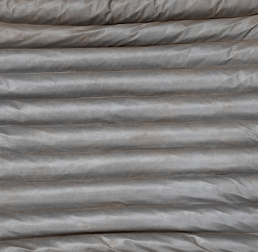 close up photo of grey porous geotextile used in UK manufacture of pro earth environment protection products