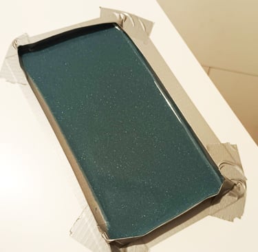 excess resin is poured out flat on a plastic plate