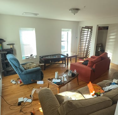 Estate home filled with furniture and clutter before junk removal cleanout