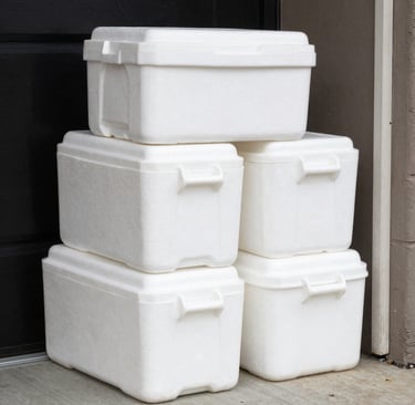 a man in a yellow hat holding a box