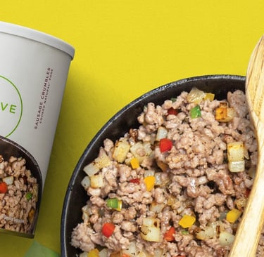 thrive sausage crumbles in a skillet with wooden spoon