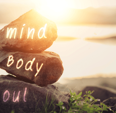 a rock stack of rocks with the words mind body soul soul