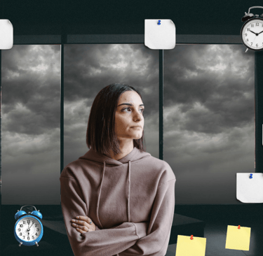 a woman standing in front of a window with a clock