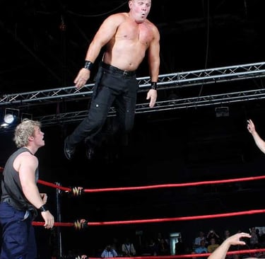 a man in a referee's uniform is jumping in the air