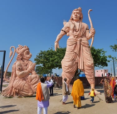 a statue of a man with a sword and a woman in a yellow dress
