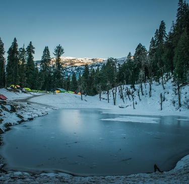 a lake with a lot of snow and tents