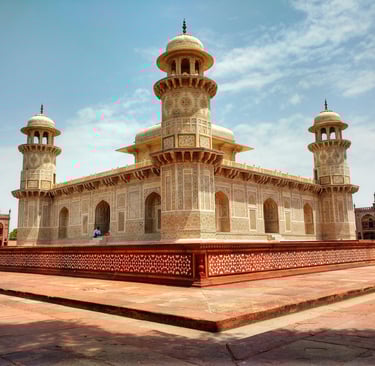 a large white building with two towers and a clock tower