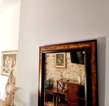 a mirror reflecting a stone wall in a room