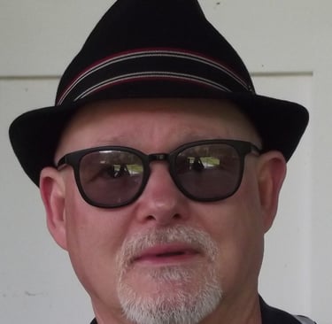 daz hull with a hat and sunglasses on a white wall