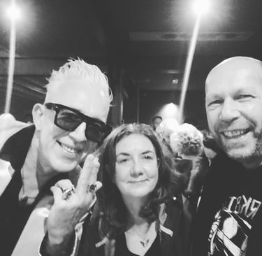 jennie lynch and her band a woman posing for a photo with two males