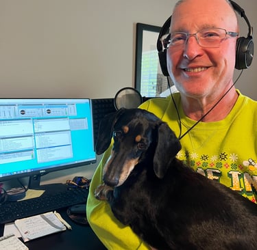 a man in a green shirt is holding a dog