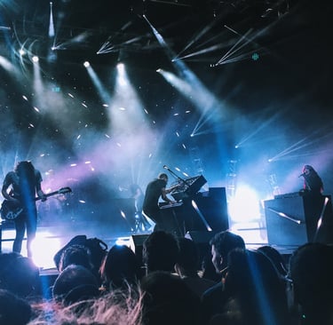 a group of people standing around a stage with a guitar