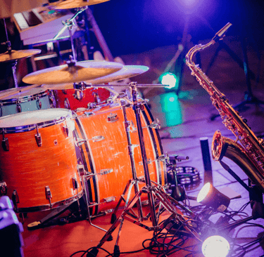 a saxophone and a set of drums on stage