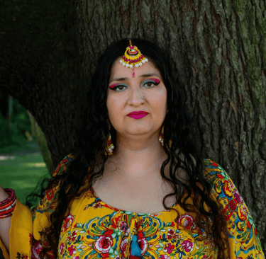 Satnam Galsian in a yellow dress, director of daz in the hat radio