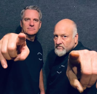 two men pointing their fingers at the camera