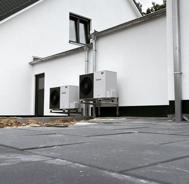 a white refrigerator and a refrigerator in front of a house