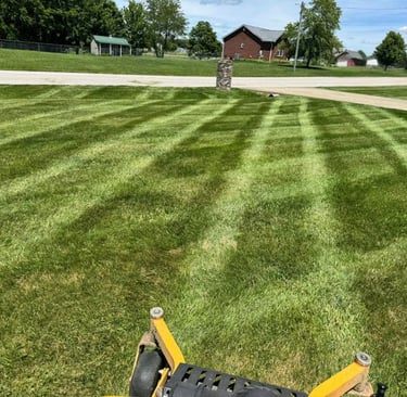 Freshly mowed lawn with clean striping from professional lawn care services by Valor Home Professionals
