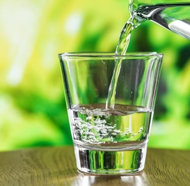a glass of water is being poured