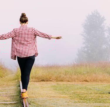 a woman walking on a railroad track