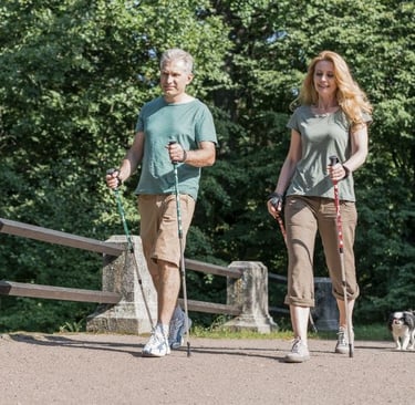 a man and woman walking with their dogs