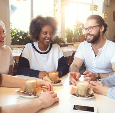 a group of friends sitting at a table with drinks