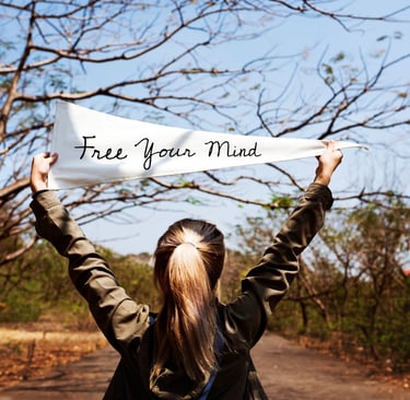 a woman holding a banner that says free your mind