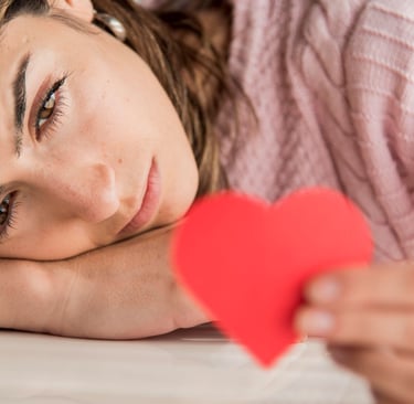 a woman holding red heart in her hand