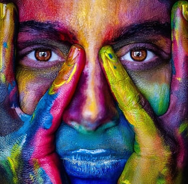 A man with painted hands on his face.