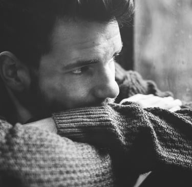 depressed man looking out the window