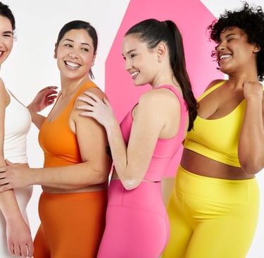 a group of women in colorful outfits posing for a photo