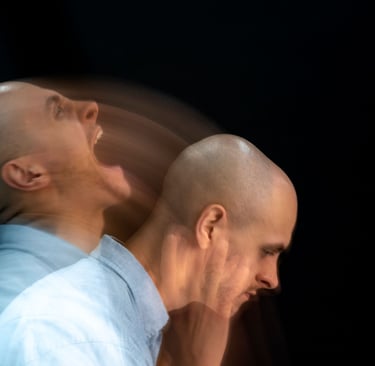 two bald men standing next to each other