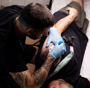 a man getting a tattoo on his arm