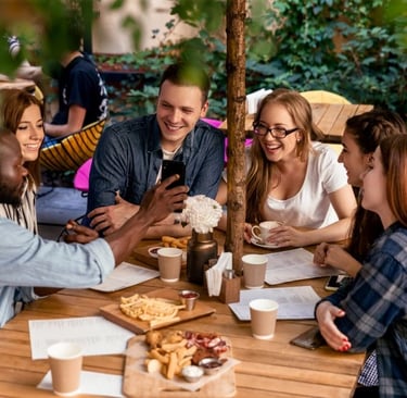 a group of friends sitting around a table