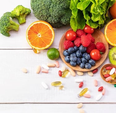 a variety of fruits, vegetables and vitamins on a table