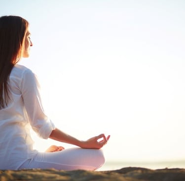 a woman sitting in a meditation position