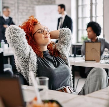 a woman with red hair sitting at a table