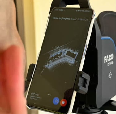 A smartphone mounted on a FARO Orbis laser scanner displaying a real-time 3D floor plan point cloud.