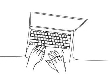 a person's hands on a laptop computer