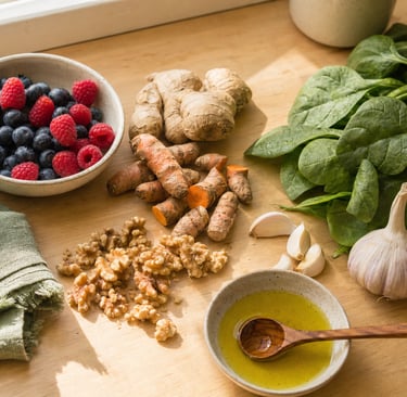 Healthy superfoods on a wooden counter including blueberries, spinach, ginger, walnuts, and turmeric.