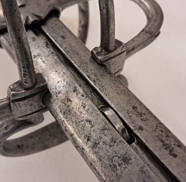 Detail of the grooved metal sleeve and locking latch on the extending rapier.
