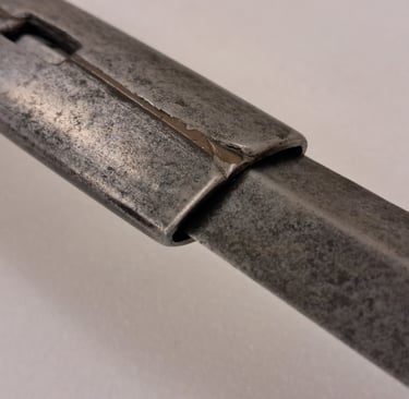 Detail of the locking notch, metal sleeve and diamondsection blade of the extending rapier.