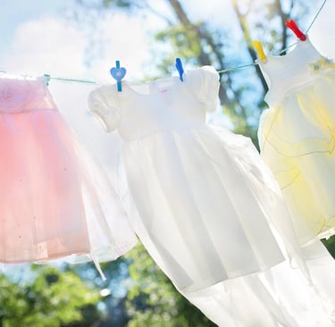 a baby's clothes hanging on a clothes line