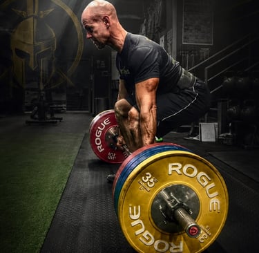 Graham Harding lifting weights in gym as founder of Ageless Warrior