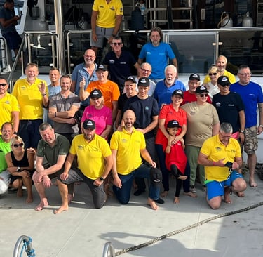a group of people standing on a diving safari boat