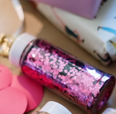 A jar of pink hexagonal glitter for DIY crafts and gift wrapping projects.