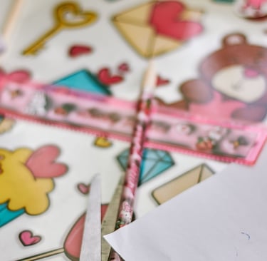 Creative arts and crafts desk with a teddy bear notebook, pink ruler, and cute stickers.