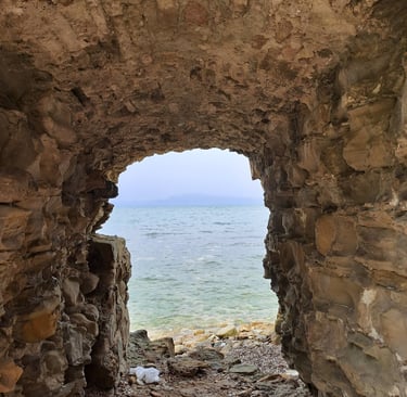a stone archway leading to the ocean